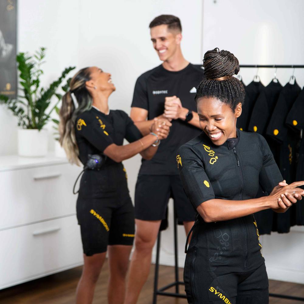 two females training in EMS training suits