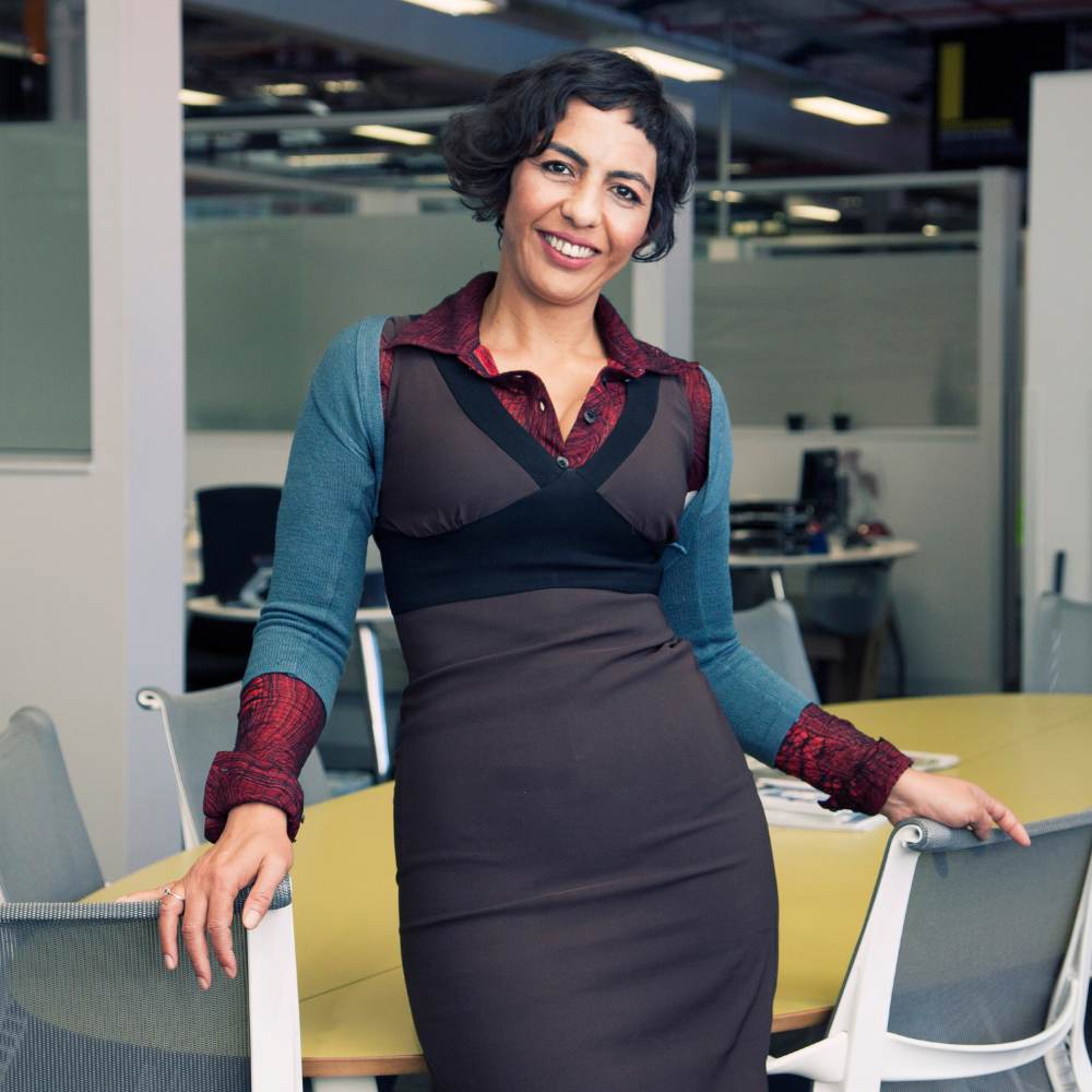 Middle-aged Female standing in front of an office desk