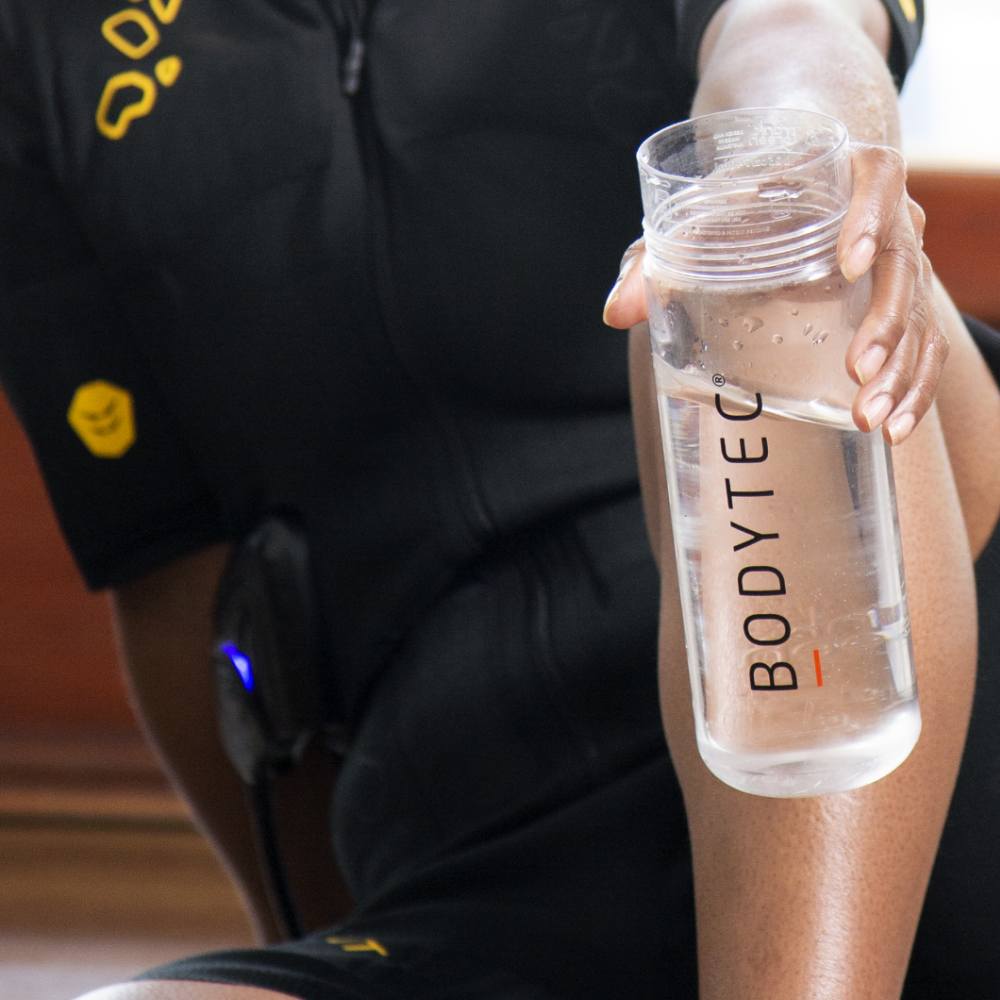 a female holding a water bottle